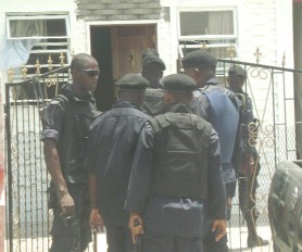 Policemen at the Lot 2442 Cul-de-Sac house yesterday