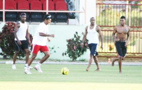CARICOM All Stars players Darren Ganga, Dwayne Bravo and Darren Bravo enjoy a game of football as part of their workout session yesterday at the stadium. 