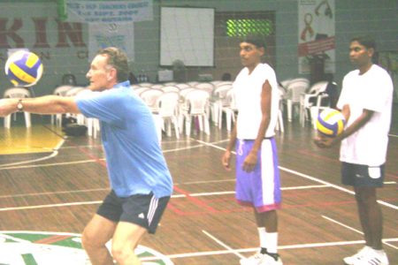  Instructor Eduardo Bellman demonstrates the correct way to receive a pass in volleyball. 