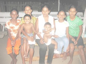 Sherry Surujpaul, centre with 11-month-old Dinesh, flanked by her daughters from right: Seeta, 17, Navita, 11, Champa, 14, Cindy, 12, and three-year-old Ajay.