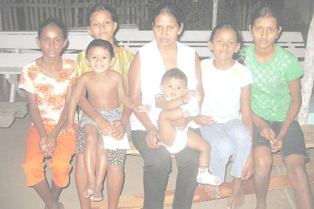 Sherry Surujpaul, centre with 11-month-old Dinesh, flanked by her daughters from right: Seeta, 17, Navita, 11, Champa, 14, Cindy, 12, and three-year-old Ajay.