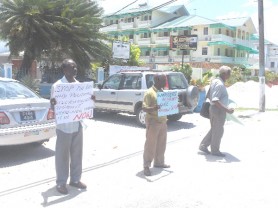 GTUC’s General Secretary Norris Witter, left, was among those protesting in front of  the Ministry of Education yesterday. 