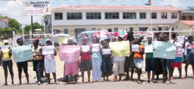 Parents staging a protest in front of the regional office at Fort Wellington yesterday. 