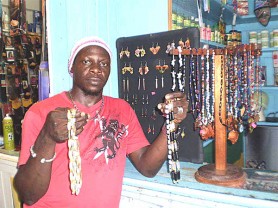 Desney Weekes holding some beaded chains at his Mackenzie stall