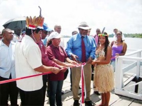 From left are Orealla/Siparuta Toshao Mc Lean De Vair; Minister of Amerindian Affairs Pauline Sukhai; and Prime Minister Sam Hinds as they prepare to cut the ribbon formally opening the $5M wharf at Orealla.   