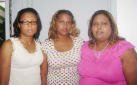 Grieving: From right are two of Motilall Singh’s sisters, Savitri Singh and Emawattie Jagan. At left is family friend, Natasha Pollard.  