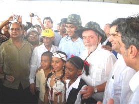 The wet weather did not dampen any spirits at the official opening of the Takutu Bridge yesterday. From left, Commerce Minister Manniram Prashad, Finance Minister Dr Ashni Singh, Ambassador to Brazil Harrinarine Nawbatt, President Bharrat Jagdeo and Brazilian President Luiz Inácio Lula da Silva pose for photographs on the bridge with these young citizens who helped cut the ribbon. (Photo by Mark McGowan)