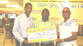 Courts Marketing Assistant Pernell Cummings (left)  presents the cheque to Jerome Khan, captain of Lusignan Golf Club (right) while Troy Peters, Public Relations Officer of the LGC looks on.    