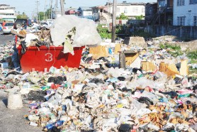 Garbage has practically taken over Sussex Street, Albouystown. Several other city streets have a similar appearance. (Photo by Jules Gibson)