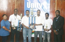 SPOILS SHARED! Captains of ECC and GNIC Abilash Dookie and Collis Butts respectively, hold the championship trophy as Captain of MSC Steven Jacobs holds his trophy for the best batsman and his team’s trophy for winning the preliminary rounds. Also in the photo are Rajendra Chandrika, who made the highest individual score of 150 not out, GCA president Alfred Mentore and GT&T’s Marketing Officer 1 Phaedra Cramer-Phillips. (Orlando Charles photo)       