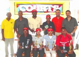 Joann Deo (second right sitting) with other winners and officials of Courts and the Lusignan Golf Club.  