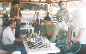 Action in the Guyana Chess Federation’s senior and junior qualification tournament on Sunday at the Keishars Sports Club building on Hadfield Street. (Orlando Charles photo)   