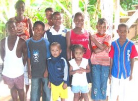 Leona Benjamin (standing left at back) with Eon and Madonna (first and second right) and seven other grandchildren she takes care of. 