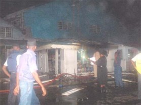 Police ,City Constable officers  and officers of the Guyana Fire Service at the scene of the fire last evening. 
