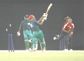 Dwayne Bravo (r) bowls Sauid Drepaul (centre) to wrap up the Guyana  innings at the Providence National Stadium on Friday night. (Orlando Charles)