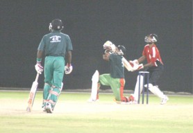 Narsingh Deonarine hits out for another six in his resistant yet futile innings. (Orlando Charles photo) 