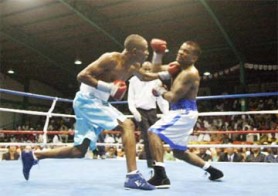 On the button! Leon Moore connects one of his trade mark left hands to the chin of Mauricio Pastrana during their super bantamweight fight which the Guyanese won by  a unanimous decision. (Orlando Charles Photo)  