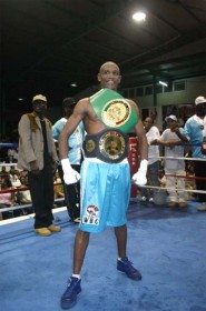 I DID IT! Shondell Alfred proudly displays the world title belt while at right, Leon `Hurry Up’ Moore shows off two of the three belts he won on Saturday night at the Cliff Anderson Sports Hall by defeating Mauricio Pastrana of Colombia. (Orlando Charles photos) 