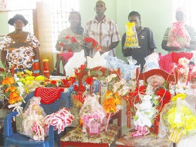 Posing with craft items: Mark Archibald (second right), Pansy David (second left) and Judy Archibald (left) with two other members. 