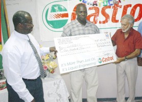 OILING UP! Guyoil’s Chairman of the Board of Directors Dr. Bud Mangal (right) hands over his company’s cheque of $200,000 to president of the GABBFF Frank Tucker while 2009 Mr. Guyana Oswin Jones (centre) looks on. (Orlando Charles photo) 