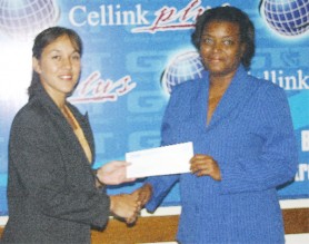 Continuing the alliance! GHB assistant secretary/treasurer Trisha Fiedtkou receives the sponsorship cheque from GT&T’s Marketing Assistant Allison Parker in aid of the annual GHB Open indoor tournament (Orlando Charles photo)  