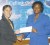 Continuing the alliance! GHB assistant secretary/treasurer Trisha Fiedtkou receives the sponsorship cheque from GT&T’s Marketing Assistant Allison Parker in aid of the annual GHB Open indoor tournament (Orlando Charles photo)  