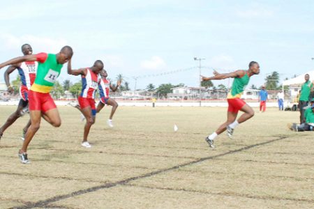 No photo finish in this upset! GDF’s Quincy Clarke (right) dips at the line ahead of Rupert Henry (left) and Keith Roberts (centre) in the 200m final of the Joint Services championships yesterday at Camp Ayanganna ground.    