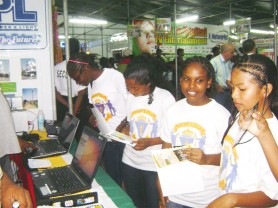 Checking bills? Something at this Guyana Power and Light booth seems to have caught the interest of these lasses from President’s College, who were among a group from the school that toured the exhibits at GuyExpo 2009 at the Sophia Exhibition Centre yesterday. (Gaulbert Sutherland photo) 