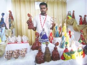 Man and his dolls: While many might think that dressing dolls is only pursued during the childhood years, Mohamed Kahmar has taken a different view and does this to earn his living. It is his main source of income, he said. The Number Two Village, West Coast Berbice resident (and his dolls) were participating in GuyExpo 2009 for the first time and were one of the attractions yesterday. Kahmar said that thus far, the experience was “okay.” The man has been dressing dolls since 1996 and says that he purchases the dolls and dresses them in his creations. He also makes ceramic dolls and little wooden ships. According to Kahmar, people are interested and are buying. Especially popular, he said, are the dolls dressed in banana leaves. Kahmar operates out of his home and many of his dolls are made to order. (Photo by Gaulbert Sutherland)       