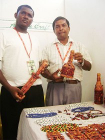 Ashraf Mohammed Ally (right) and his nephew Colin Nero at their booth at GuyExpo 2009 yesterday. 