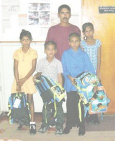The Pooranmals: From right, ten-year-old Anita Pooranmal and her siblings, nine-year-old Sanjay called Radesh; eight-year-old Ritesha and seven-year-old Avinash are seen with their father at the ministry on the day they were released into the custody of their uncle. 