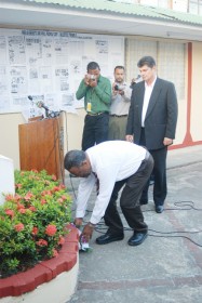 Prime Minister Samuel Hinds lays a wreath at the monument commemorating the Cubana Air disaster located in the Cuban Embassy. Yesterday marked 33 years since the bombing occurred killing all 73 on board. Standing behind the Prime Minister is the Cuban Ambassador Raul Marrero. (Jules Gibson photo) 