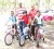 Nicholas Nandan, Deeraj Garbaran and Christopher Griffith pose with National Cycling Coach Hassan Mohammed and their new bikes. (Aubrey Crawford photo)