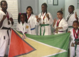 The Pan Caribbean martial arts winners kept the Golden Arrowhead flying high at the Trinidad championships. Sensei Troy Bobb is at left.    