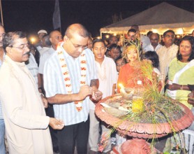 President Bharrat Jagdeo (second from left) lighting the national diya yesterday at the Promenade Gardens. The Guyana Telephone and Telegraph Limited, the Indian Arrival Committee and the Indian Com-memoration Trust collaborated to present the inaugural Rashtra Jyoti (symbolic lighting) of the national diya. The lighting was preceded by a cultural programme. The Hindu Festival of Diwali will be celebrated tomorrow. (Jules Gibson photo)