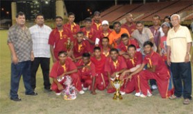 The winning Albion team poses with their spoils from the final with CEO of Neal and Massy Deo Persaud (second right) and President of the Guyana Cricket Board (GCB) Chetram Singh (left). (Aubrey Crawford photo)         