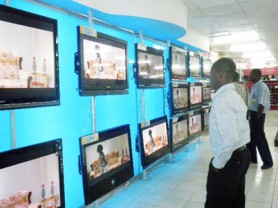 Invitees viewing the new display of flat screen televisions at Courts, Main Street last evening