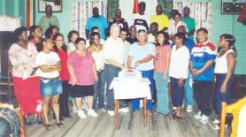 David and Doreen de Caires surrounded by staff members cut the cake on Stabroek News’s twentieth anniversary, November 2006.