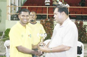Man-of-the-match Shivenarine Chanderpaul is presented with his trophy by Guyana Cricket Board (GCB) President Chetram Singh after Guyana defeated CCC by six wickets yesterday. (Orlando Charles photo)