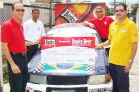 Banks Beer Brand Manager Brian Choo Hen (left) presents the cheque to Gavin Gouveia while Banks executives  Carlton Joao and Errol Nelson look on.
