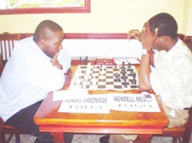 Wendell Meusa leads the National Chess Championships after eight rounds of play. He has accumulated eight points from eight games, a perfect score. In photo, Meusa faces Ronuel Greenidge, whom he despatched in both of their encounters; once with the Black pieces, then with the White pieces. The Championships are underway at the Ocean Spray Hotel in Stanley Place, Kitty.