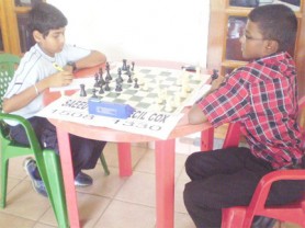 In the Junior Championships being contested at Olympic House, High Street, Kingston, Saeed Ali and Cecil Cox lead the tournament with six points each from the eight rounds which have been completed. Saeed lost his first and only game to Cecil last weekend, making the outcome of the tournament difficult to predict. In photo, Saeed and Cecil concentrate on their next moves. 
