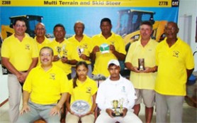 Sitting (l-r) MACORP Chief Executive Officer Jorge Medina, Winner Joaan Deo and Avinash Persaud with other prize winners and officials of MACORP and the Lusignan Golf Club.  