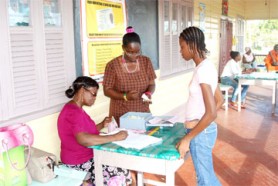 ID card distribution at the St Christopher Nursery School, North Ruimveldt. (See story on page 12.) 