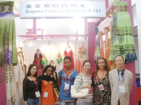 Designers Chandini Ramnarine, Ronella Woseley, Marica DeSantos and Sonia Noel (second, right) with Chinese officials at the Guyana booth at the Ningbo International Fashion Expo in China. (Photo courtesy of Sonia Noel)