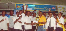 Managing Director NAMILCO, Bert Sukhai (3rd right) presents the 2009 NAMILCO Trophy and the winning cheque to Sunburst Camptown’s captain, Orlando Gilgeous while other team-mates and members of NAMILCO share the moment.