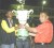Champs again! Regional Chairman of Region 6, Zulfikar Mustafa (right) hands the over-all trophy to Upper Demerara’s and National Under-16 Champion Athlete Parish Cadogan (left) at last evening closing and presentation ceremony. Hidden in photo is Upper Demerara’s team manager Mayfield Taylor-Trim. (Orlando Charles photo) 