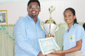 Sonya Valini Yacoob (right) receives her awards from Minister of Housing and Water Irfaan Ali.