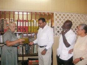 For preservation: Wife of the late Dr Denis Williams Toni Williams (left) hands over his manuscripts to Minister of Culture, Youth and Sport, Dr Frank Anthony yesterday in the presence of Director of Culture, Dr James Rose and Administrative Manager of the Walter Roth Museum Jennifer Wishart (right).   