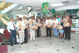 Celebrating its 15th anniversary this week, Demerara Bank Limited yesterday honoured 15 “special” customers who established and maintained accounts with the bank from its inception in 1994. The 15 were presented with hampers at the bank’s Camp Street and South Road location. The 15 are: Amir Khan, Karen Vasconcellos, Roy W. Persaud, Bryan K. Clarke, Brian Chu-A-Kong, Compton W. Clarke, Alexis Sullivan, Haffeez Mohamed, Varnay St. K Massiah, R Latchmansingh, L Goolchand, Edith Dewar, Khalil Ahmed, Dr Balwant Singh Jnr. and Lewis Kartick. In photo the recipients pose with bank officials.